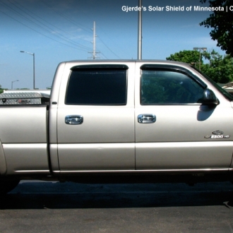 Chevy hTruck with legal window tint on fronts and limo on rears.